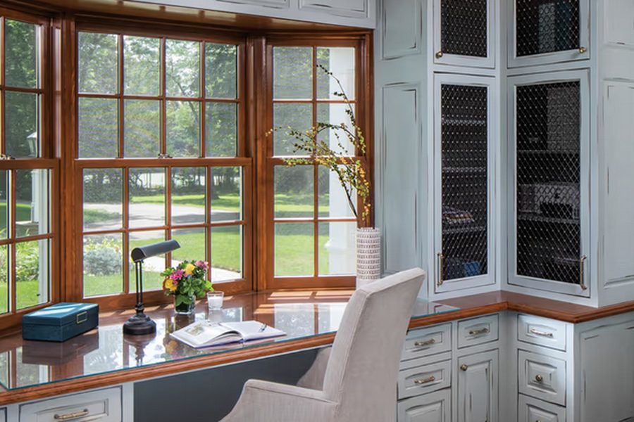Marvin Ultimate Bay window forming a wood-framed study nook with a desk beneath it