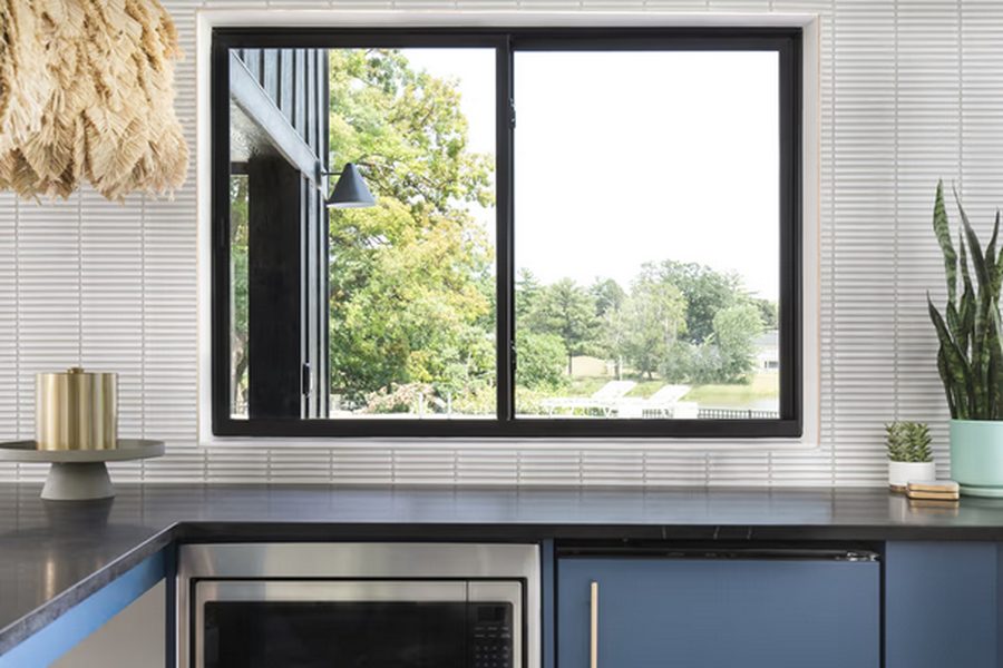 Marvin Essential Glider window above a kitchen counter, with a black frame and horizontally sliding sash